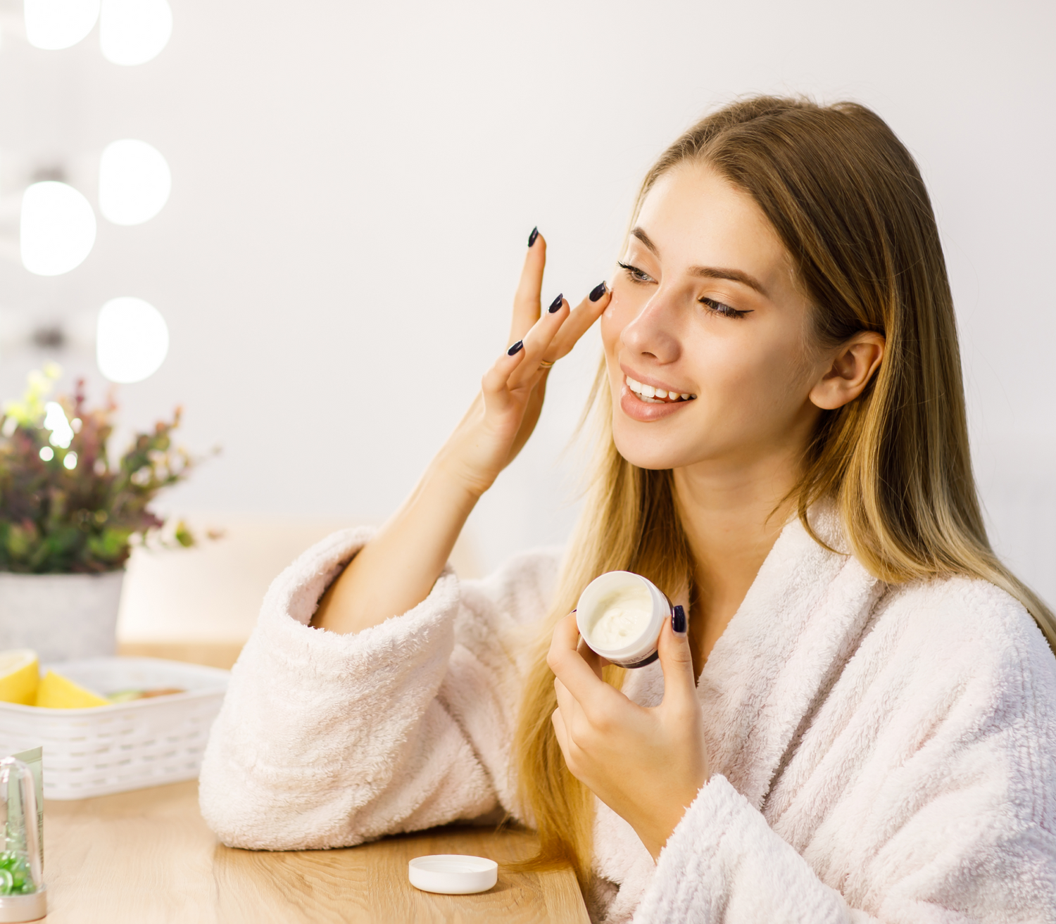 young-beautiful-blonde-girl-cares-face-skin-with-moisturizer-front-mirror 1.png__PID:3a9f8f31-79d9-4a91-b4f8-575f7d60186a